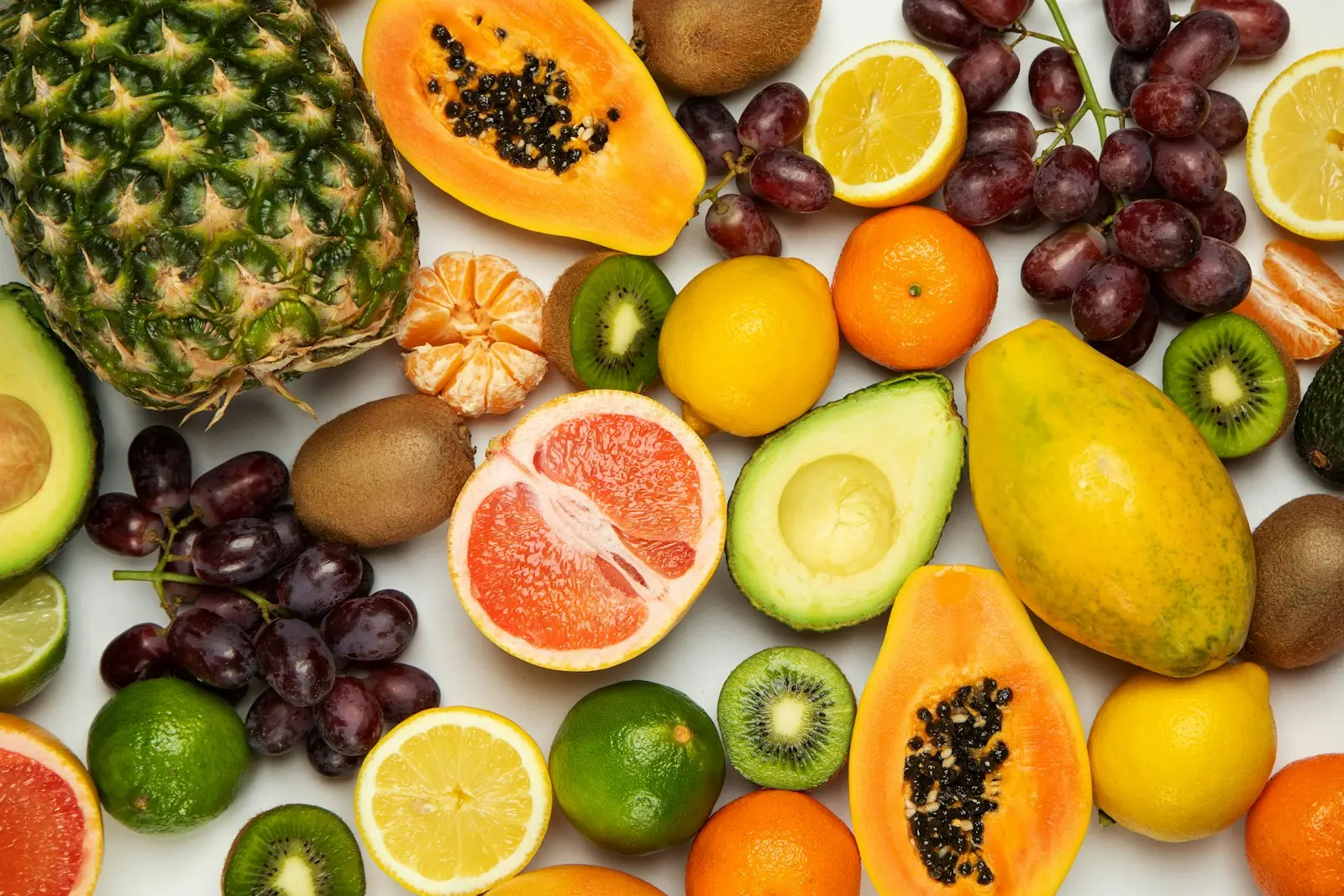 Assorted fresh fruit including pineapple, citrus, grapes and papaya, shown as illustrative produce photography